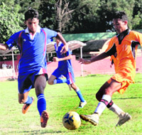 Players in action during a match in the 4th ONGC Ram Bahadur Chettri Memorial Inter-school Football Tournament in Dehradun on Wednesday. 