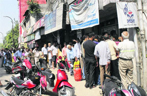 Residents queue up at a gas agency in Jammu on Wednesday.