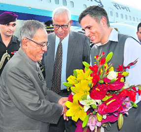 President Pranab Mukherjee with J-K CM Omar Abdullah and Governor NN Vohra at the Srinagar international airport on Wednesday.