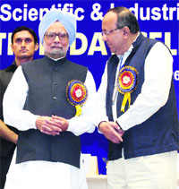 Prime Minister Manmohan Singh interacts with CSIR Director General Samir K Bramachari in New Delhi on Wednesday.