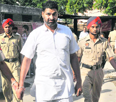 Nissan Singh, head constable, being produced in a district court at Phase III B-I, Mohali, on Thursday. 