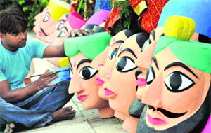 An artist gives final touch to Rajasthani puppets for street art festival near Sukhna Lake in Chandigarh on Thursday. 