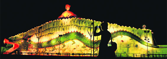 A visitor takes photographs of a dragon made of plaster of Paris at Sector 34 in Chandigarh on Thursday.