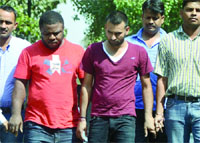 The accused in police custody in New Delhi on Thursday. Tribune photo: Manas Ranjan Bhui