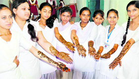 School girls show various designs of mehndi on their hands at a co-curricular programme organised by the Rotary Club at Jwalapur Intermediate College in Haridwar on Wednesday.