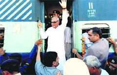Chief Minister Bhupinder Singh Hooda boards a train at the Lakhanmajra railway halt in Rohtak district on Thursday. Photo: Manoj Dhaka