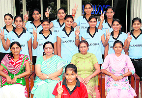 Players of LPU and IIT-Lucknow (in green T-shirt) kick the ball during the inaugural day of the North Zone Inter-University Football (Men) Championship held near Jalandhar on Thursday; and (right) the team of KMV Collegiate Senior Secondary School, Jalandhar, that has won the volleyball tournament in the Jalandhar District Inter-School Championship