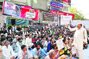 MLA Engineer Abdul Rashid addresses demonstrators during a sit-in in Srinagar on Thursday. 