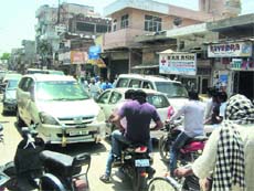 Vehicles stuck in a traffic jam due to haphazard parking on College Road in Jagraon on Thursday. 