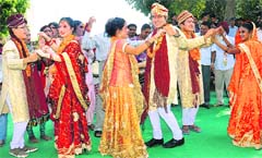 Couples dressed in traditional Punjabi wedding attire participate in the 7th International Peace Fest at Sarangpur village in Chandigarh on Friday. 