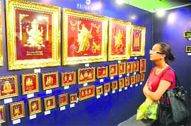 A visitor admires gold-plated artwork of Thailand during a trade show at Himachal Bhawan in Sector 28, Chandigarh, on Friday. 
