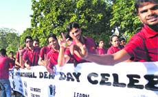 Hearing impaired youth display a banner during a march to celebrate International Deaf Day in Sector 16, Chandigarh, on Friday. 