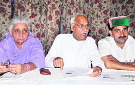 HPCC senior vice-president Chander Kumar (centre), flanked by Chandresh Kumari and Kewal Singh Pathania, addresses mediapersons in Dharamsala.