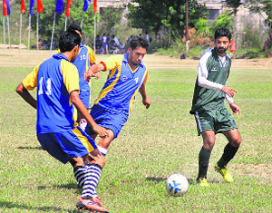A match in progress between Jamia Millia Islamia and Uttarakhand Technical University (in blue dress) during the North Zone Inter-University Football Championship at Lovely Professional University near Jalandhar on Friday. 