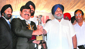 Deputy Chief Minister Sukhbir Badal honours an entrepreneur during the meet of the Confederation of Indian Industries near Jalandhar on Friday. 