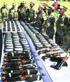 Army personnel display a huge haul of arms seized in Kupwara on Friday. 