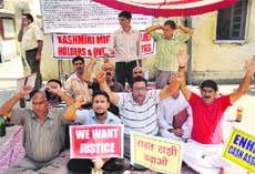 Kashmiri Pandits protest outside the Relief Commissioners office in Jammu on Friday.
