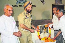 Joginder Paul Singh, DIG, Jammu, along with members of the J&K Freedom Fighters Association pays floral tributes to Shaheed Bhagat Singh at DBN School, Mubarak Mandi, in Jammu on Friday.