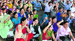 Members of the teachers union raise slogans during a state-level rally at Grain Market in Ludhiana on Friday