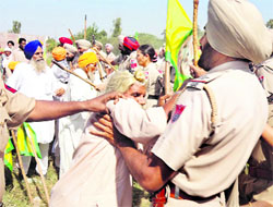 Farmers clash with the police after power officials tried to install meters outside their houses at Chaminda Kalan village in Amritsar on Friday. A Tribune photograph