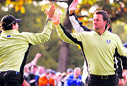 Europes Rory McIlroy and Graeme McDowell celebrate after winning a hole during the foursomes round at the Ryder Cup in Medinah, Illinois, on Friday