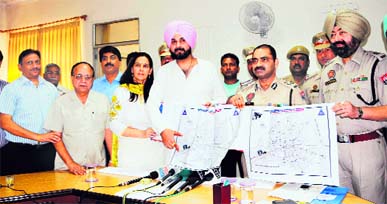 Member of Parliament Navjot Singh Sidhu, Chief Parliamentary Secretary Navjot Kaur Sidhu along with police officials releases the traffic plan in Amritsar on Saturday.