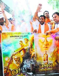 Activists of the Shiv Sena burn a poster of the Bollywood film Oh My God during a demonstration outside a cinema hall in Amritsar on Saturday.
