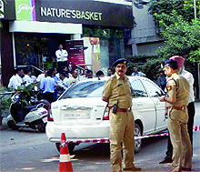 A file photo of policemen inspecting the car used in the robbery 