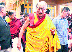 The Dalai Lama comes out from the main Buddhist temple after offering prayers for world peace in McLeodganj on Saturday