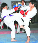 Players in action during a bout in the Karate Championship in Jammu on Saturday. Tribune photo: Inderjeet Singh