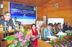 Minister of State for Agriculture Ghulam Hassan Mir addressses a seminar on globalisation at University of Kashmir in Srinagar on Saturday. photo by writer