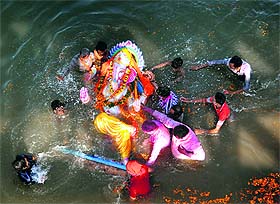 Devotees immerse an idol of Lord Ganesh on the concluding day of Ganesh Chaturthi in Ludhiana on Saturday.