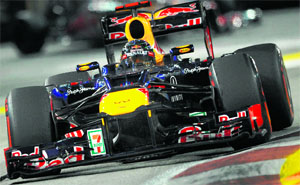Red Bull-Renault driver Sebastian Vettel of Germany in front and McLaren-Mercedes driver Jenson Button of Britain (back) during the Formula One's Singapore Grand Prix 