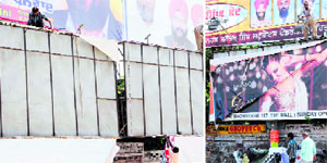 Workers of private companies remove hoardings after their contracts expired in Amritsar on Sunday.
