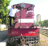 After the Railway authorities announced the closure of Hanumangarh-Sadulshahar railway track from midnight on Sunday, a commuter waives from the engine of a passenger train at Ellenabad railway station on his final ride to Sadulshahar. 