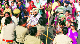 Policemen use force to stop members of the Sikhya Provider Front, Punjab, from blocking Karabara Chowk in Ludhiana on Sunday.