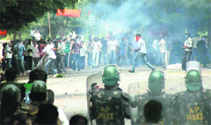 Policemen use teargas shells to disperse Osmania University students during the pro-Telangana march in Hyderabad on Sunday.