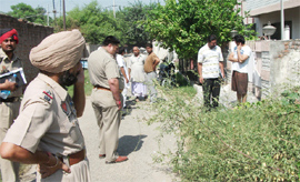 Police officials at the murder site in Amritsar on Monday.