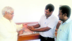 Principal DK Kaushik (left) enquires about the relics on display at the history museum of MM PG College, Fatehabad.