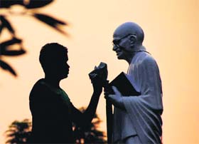 A day ahead of Gandhi Jayanti, a man cleans a statue of the Father of Nation in Jalandhar on Monday. 