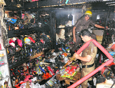 Firefighters in action at a shop in Sector 27 in Chandigarh on Tuesday. 