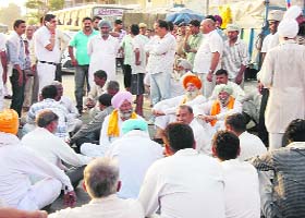 Farmers squat and block traffic near Sharadhanand Chowk, Kurukshetra, on Tuesday