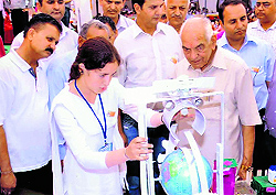 Neha, explains her model to Education Minister ID Dhiman at the Inspire Exhibition in Hamirpur
