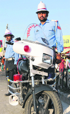 Traffic policemen with a high-tech motorcycle in Jammu. 