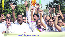 Activists of the Bharat Swabhiman Nyas protest against the FDI policy in front of the statue of Mahatma Gandhi in Jalandhar on Tuesday.