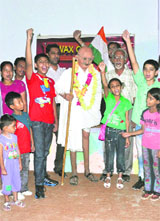 People gather around a wax statue of Father of the Nation at Prabhakar Wax Museum on Tuesday