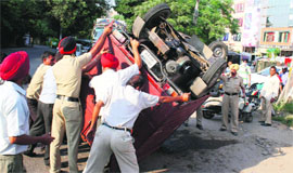 An auto that overturned after ramming into a two-wheeler on Pakhowal Road in Ludhiana on Tuesday.