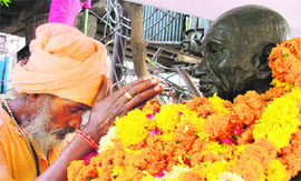 A hermit pays tribute to Mahatma Gandhi on Tuesday. 