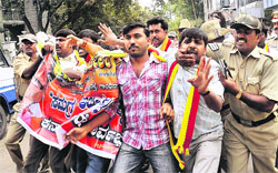Cauvery water dispute: Policemen detain activists of the Karnataka Rakshana Vedike during a protest over Cauvery water issue in Bangalore on Tuesday.  PTI