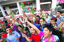 Nepalese students hold red roses as they participate in an event to mark the International Day of Non-Violence, coinciding with the birth anniversary of Mahatma Gandhi, in Kathmandu on Tuesday.